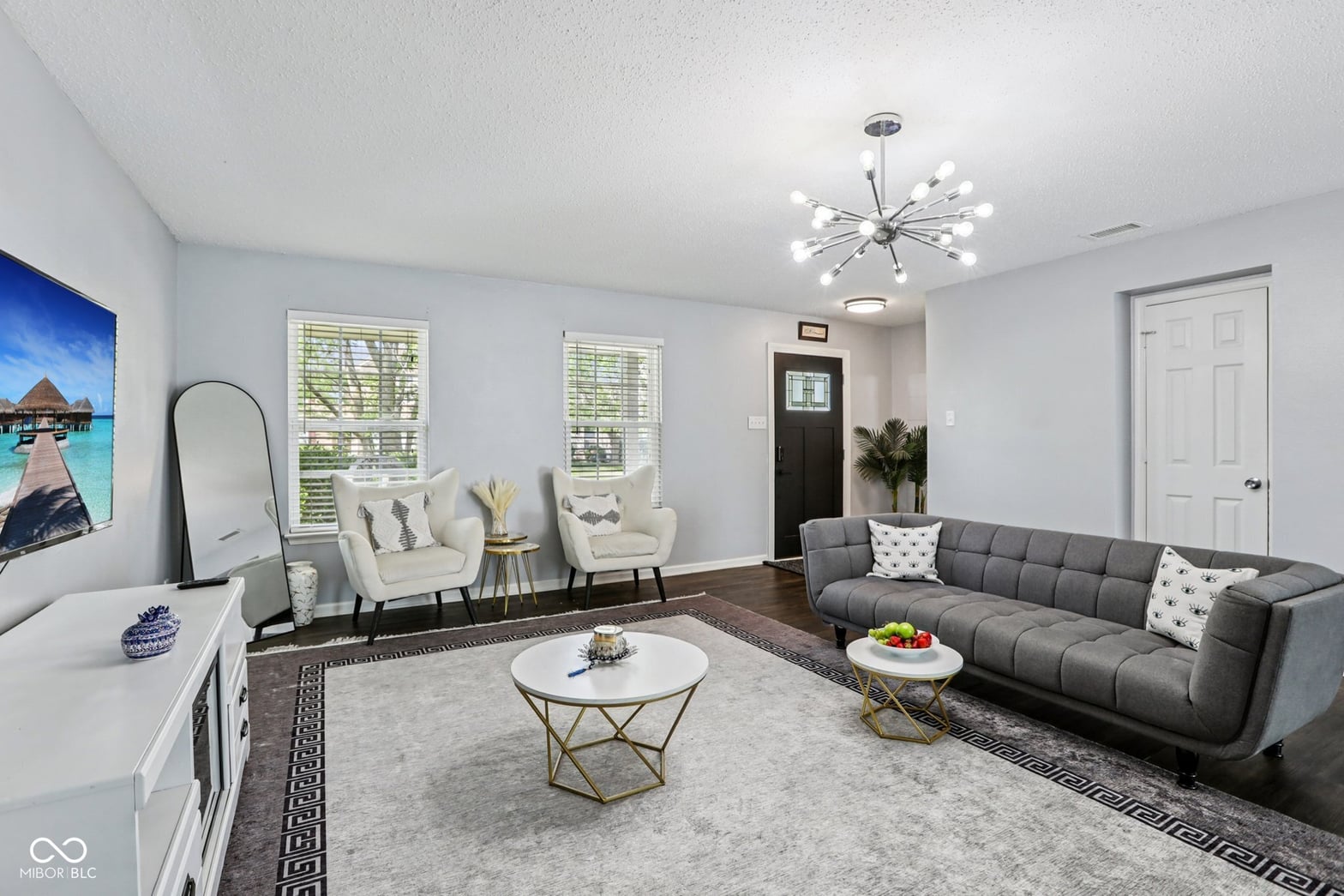 Bright contemporary living room with modern furnishings and natural light.