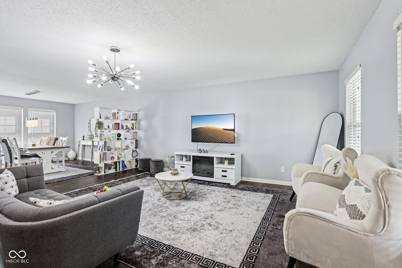 Bright contemporary family room with curved seating and storage.