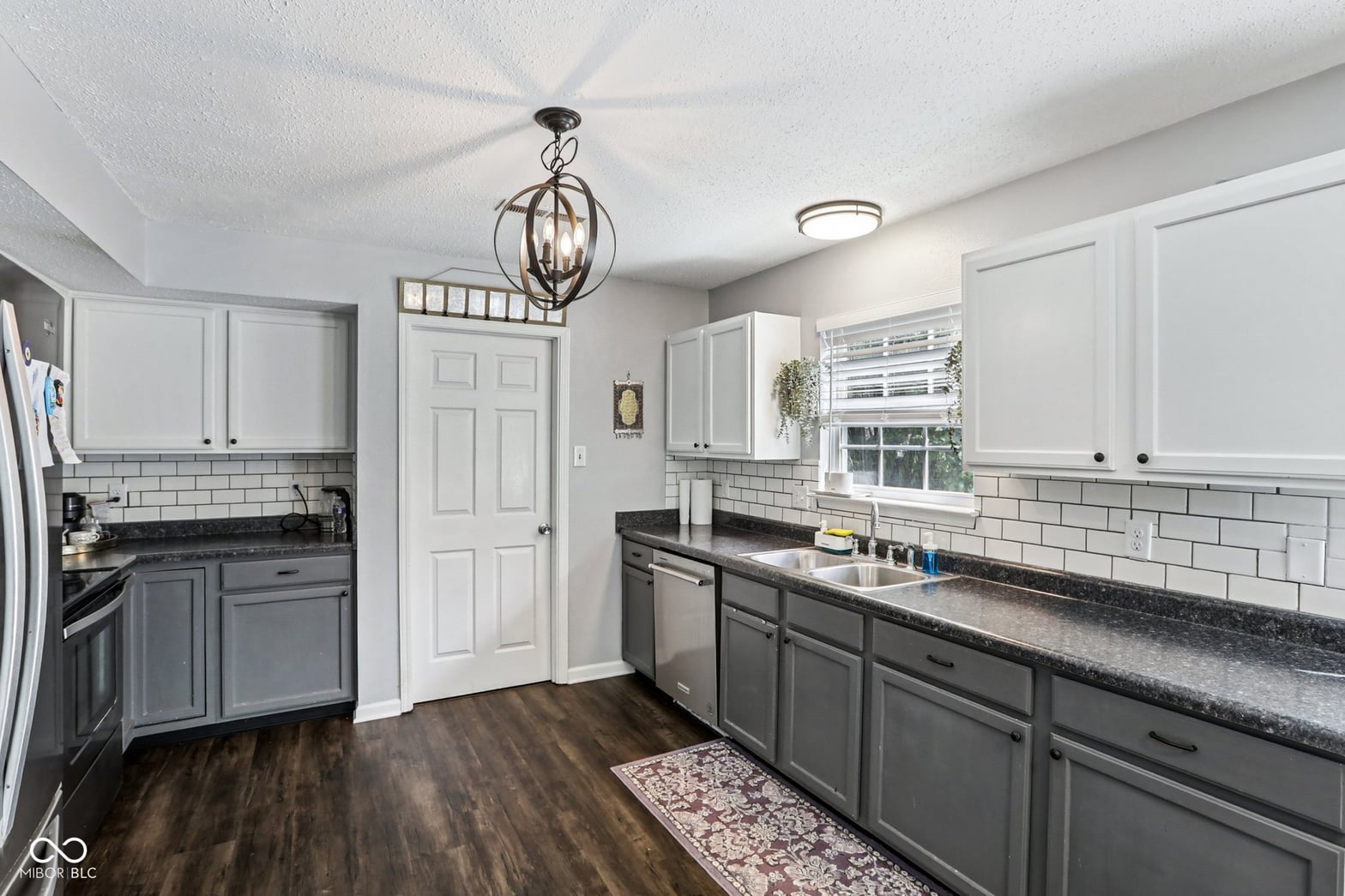 Beautifully renovated kitchen with elegant two-tone cabinetry.