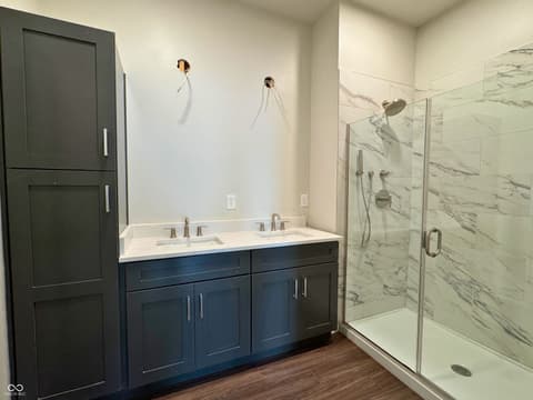 Primary bathroom at 925 Veterans Way, Carmel, IN — Luxe primary bath with double vanity and frameless shower.