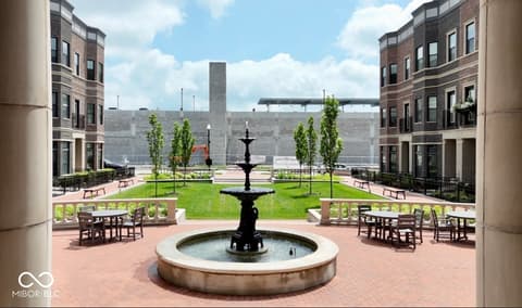 Outdoor living area at 925 Veterans Way, Carmel, IN — Elegant courtyard with fountain and outdoor seating areas.