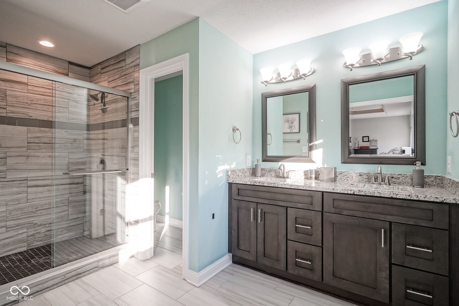 Luxurious primary bath with spa-like finishes and double vanity.