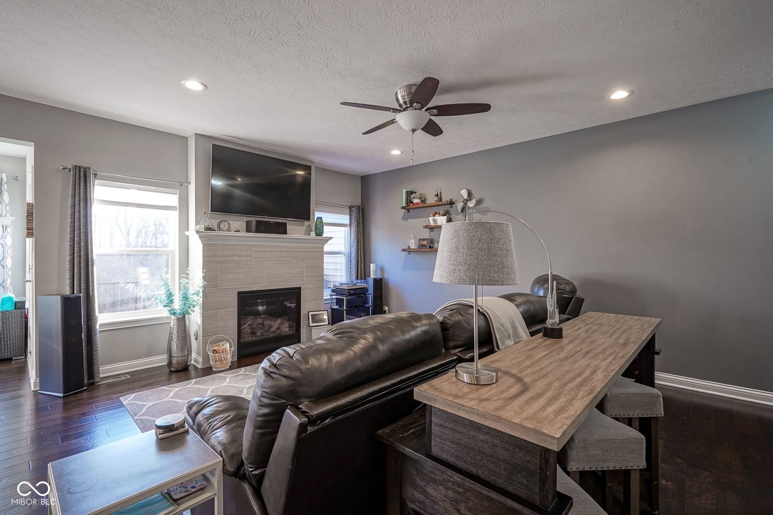 Spacious family room with fireplace and modern finishes.