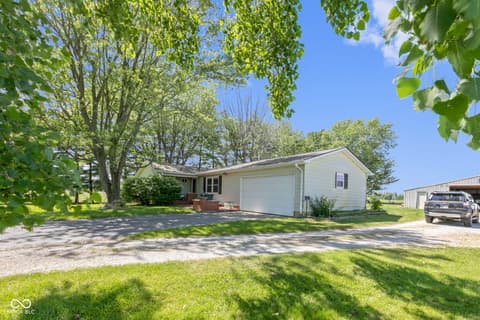 Front exterior at 8440 E 216th Street, Cicero, IN — Charming ranch on spacious, tree-lined lot with garage.