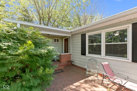 Backyard at 8440 E 216th Street, Cicero, IN — Spacious brick patio with mature privacy landscaping.