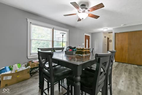 Dining room at 8440 E 216th Street, Cicero, IN — Bright dining area with large windows and ceiling fan.
