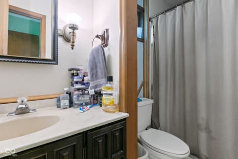 Bathroom at 8440 E 216th Street, Cicero, IN — Full bathroom with dark wood vanity and classic fixtures.