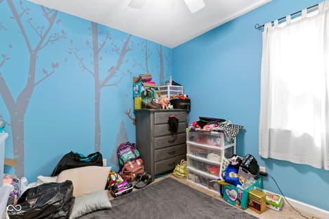Bedroom at 8440 E 216th Street, Cicero, IN — Bright bedroom with creative tree mural accent wall.