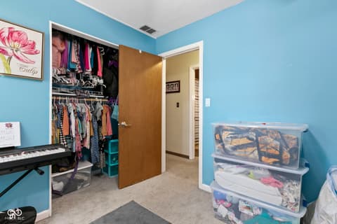 Bedroom at 8440 E 216th Street, Cicero, IN — Spacious bedroom with organized walk-in closet and storage.