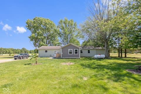 Front exterior at 8440 E 216th Street, Cicero, IN — Charming ranch on expansive wooded lot with mature trees.