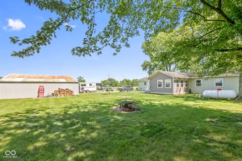 Backyard at 8440 E 216th Street, Cicero, IN — Spacious rural property with mature trees and outbuildings.