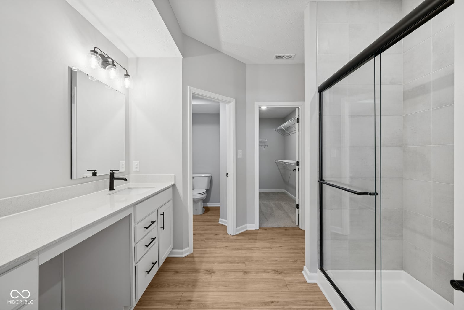 Luxurious primary bath with spa-like shower and double vanity.