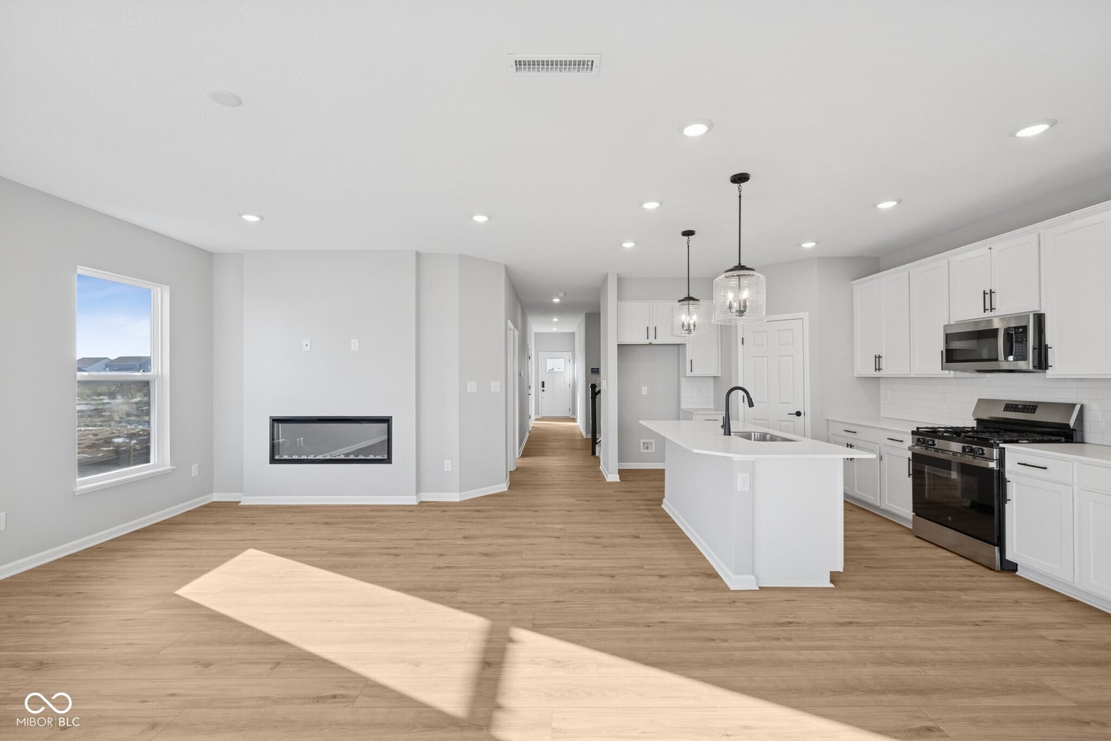 Bright modern kitchen with island and scenic water views.