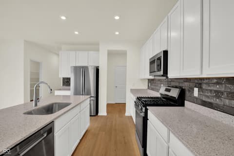Kitchen at 3932 E 191st Street, Westfield, IN — Modern kitchen with white cabinetry and quartz countertops.