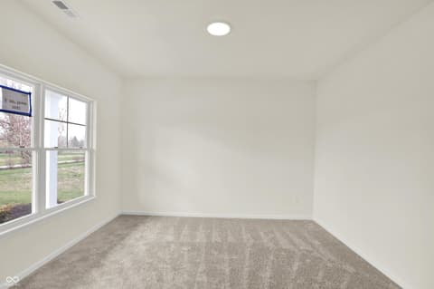 Bedroom at 3932 E 191st Street, Westfield, IN — Bright bedroom with large windows and fresh carpet flooring.
