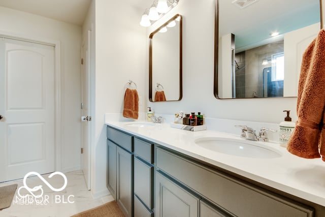 Spacious primary bath with dual vanity and modern finishes.