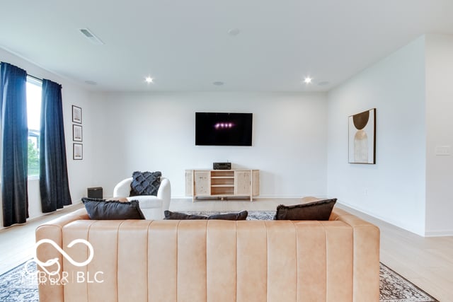 Bright, modern family room with premium seating and entertainment setup.