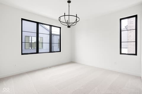 Bedroom at 1678 Coach Drive, Westfield, IN — Bright, spacious bedroom with modern black-framed windows.