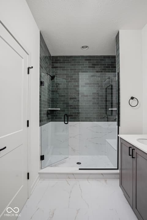 Primary bathroom at 1678 Coach Drive, Westfield, IN — Luxurious primary bath with walk-in shower and marble.