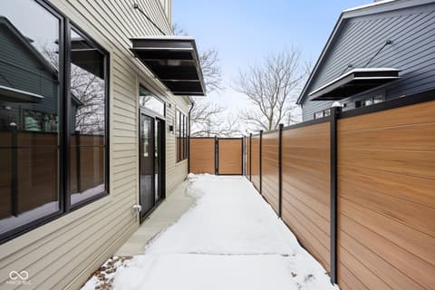 Outdoor living area at 1678 Coach Drive, Westfield, IN — Modern courtyard with pergola and composite fencing.