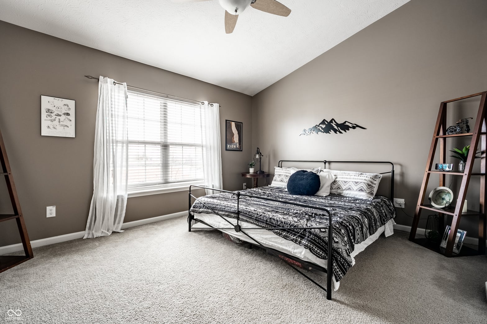 Spacious primary bedroom with abundant natural light.