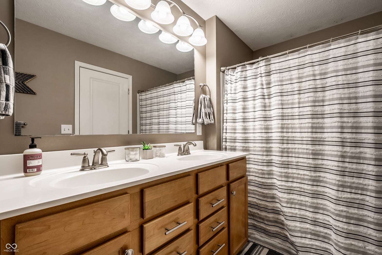 Spacious primary bath with elegant double vanity and storage.