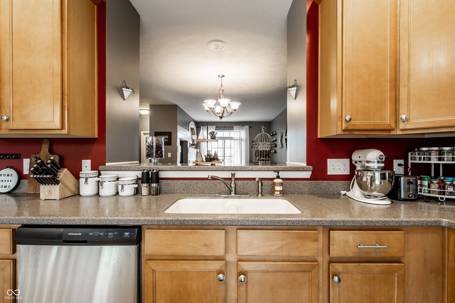 Spacious kitchen with granite counters and wood cabinets.