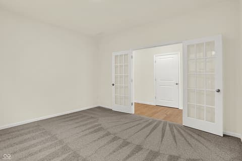 Bedroom at 19785 Highclere Lane, Sheridan, IN — Spacious bedroom with French doors and ample closet storage.
