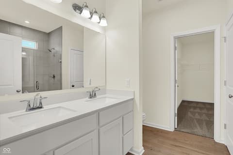 Primary bathroom at 19785 Highclere Lane, Sheridan, IN — Bright primary bath with double vanity and walk-in closet.