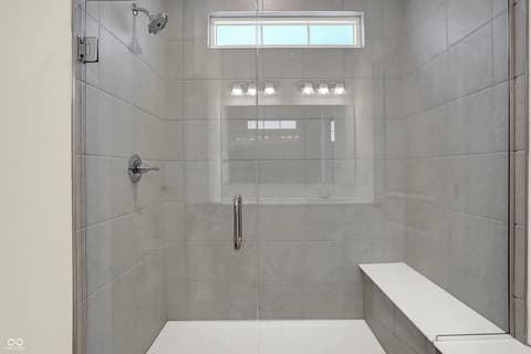 Primary bathroom at 19785 Highclere Lane, Sheridan, IN — Luxurious spa-like shower with frameless glass enclosure