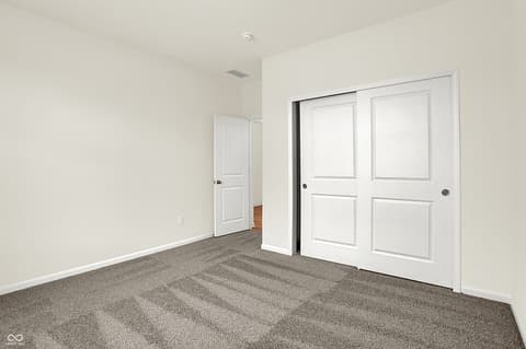Bedroom at 19785 Highclere Lane, Sheridan, IN — Bright, clean bedroom with dual sliding closets.