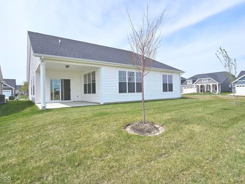 Backyard at 19785 Highclere Lane, Sheridan, IN — Modern farmhouse with spacious covered porch and open yard.