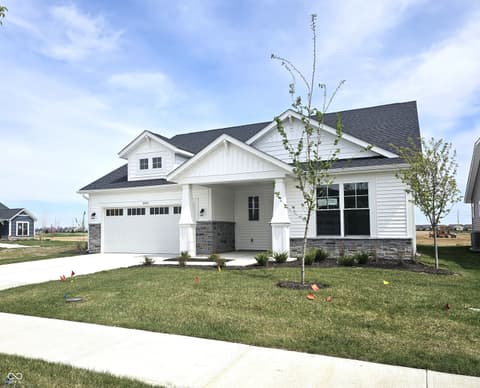 Front exterior at 19785 Highclere Lane, Sheridan, IN — Charming new farmhouse with stone accents and covered porch.