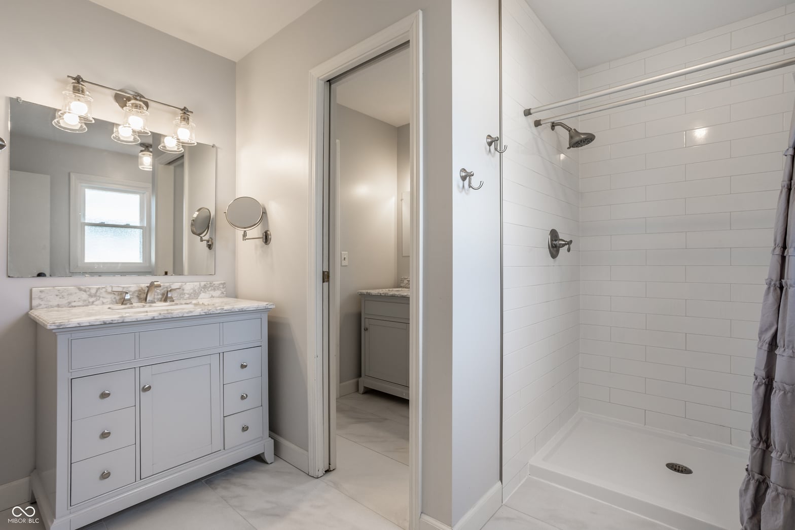 Luxurious primary bath with marble and spa shower.