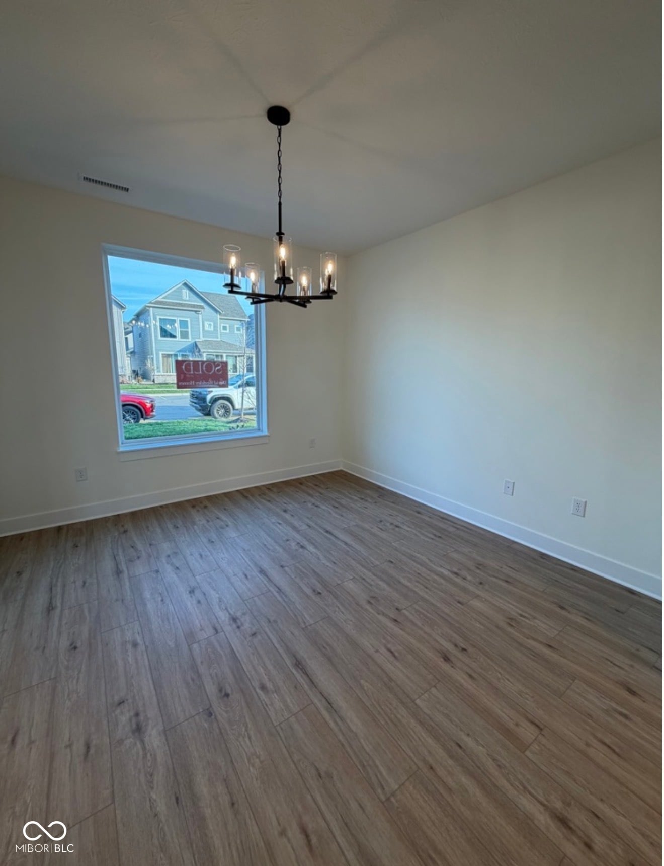 Bright dining room with hardwood floors and modern fixtures.