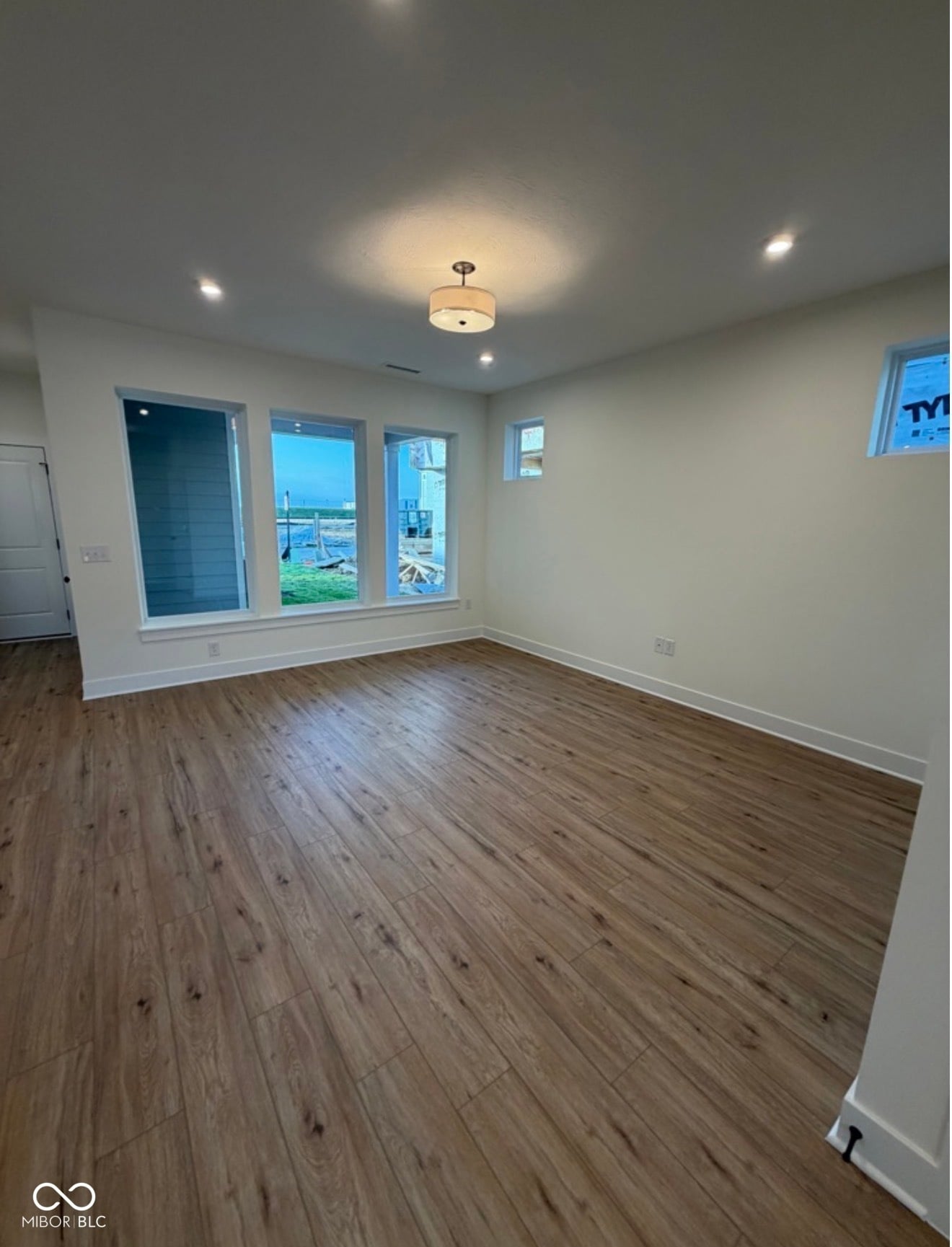 Bright modern living space with waterfront views and sliding glass doors.