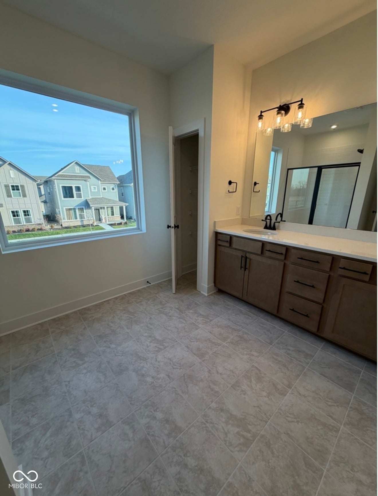 Spacious primary bath with double vanity and natural light.