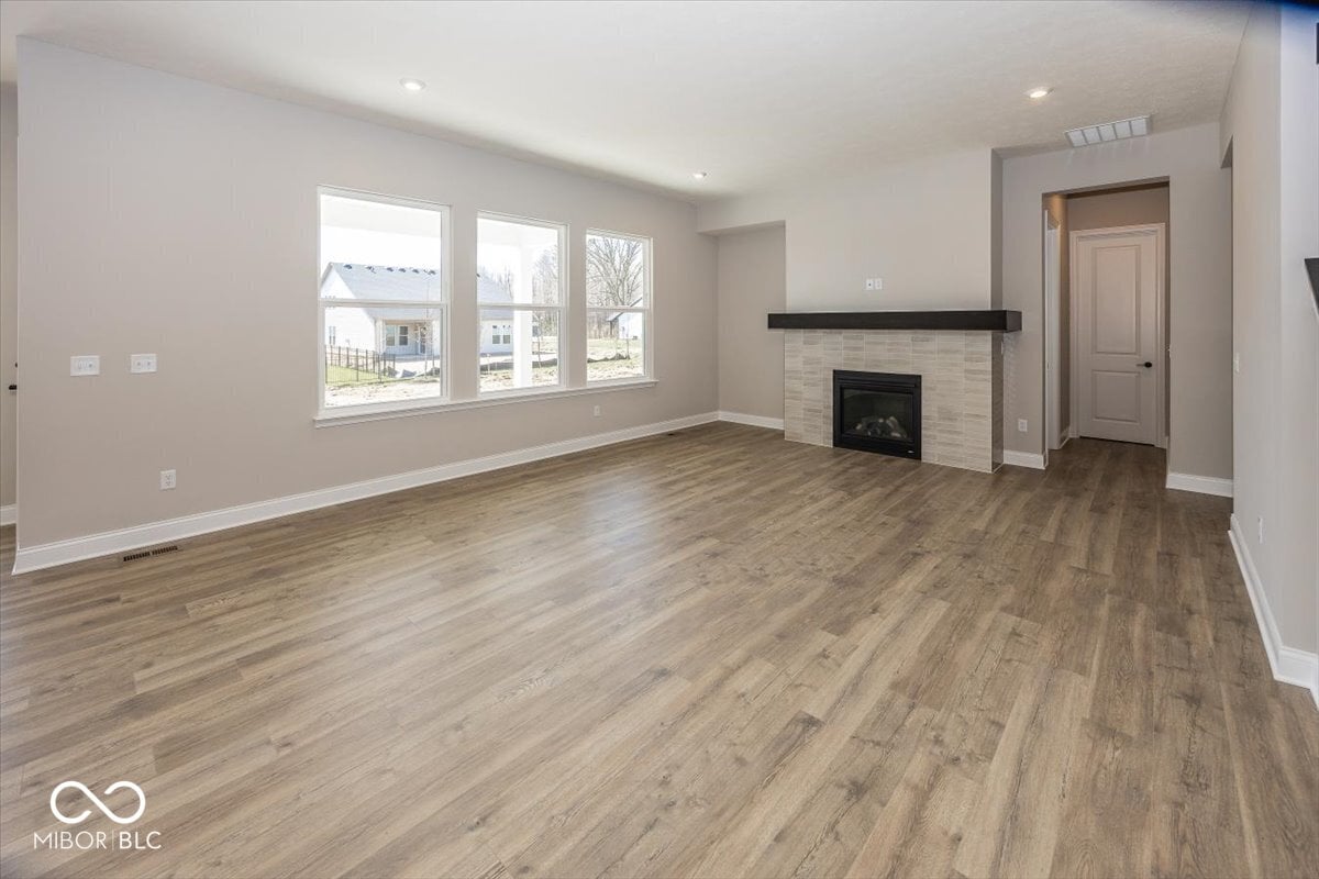 Bright living room with fireplace and abundant natural light.