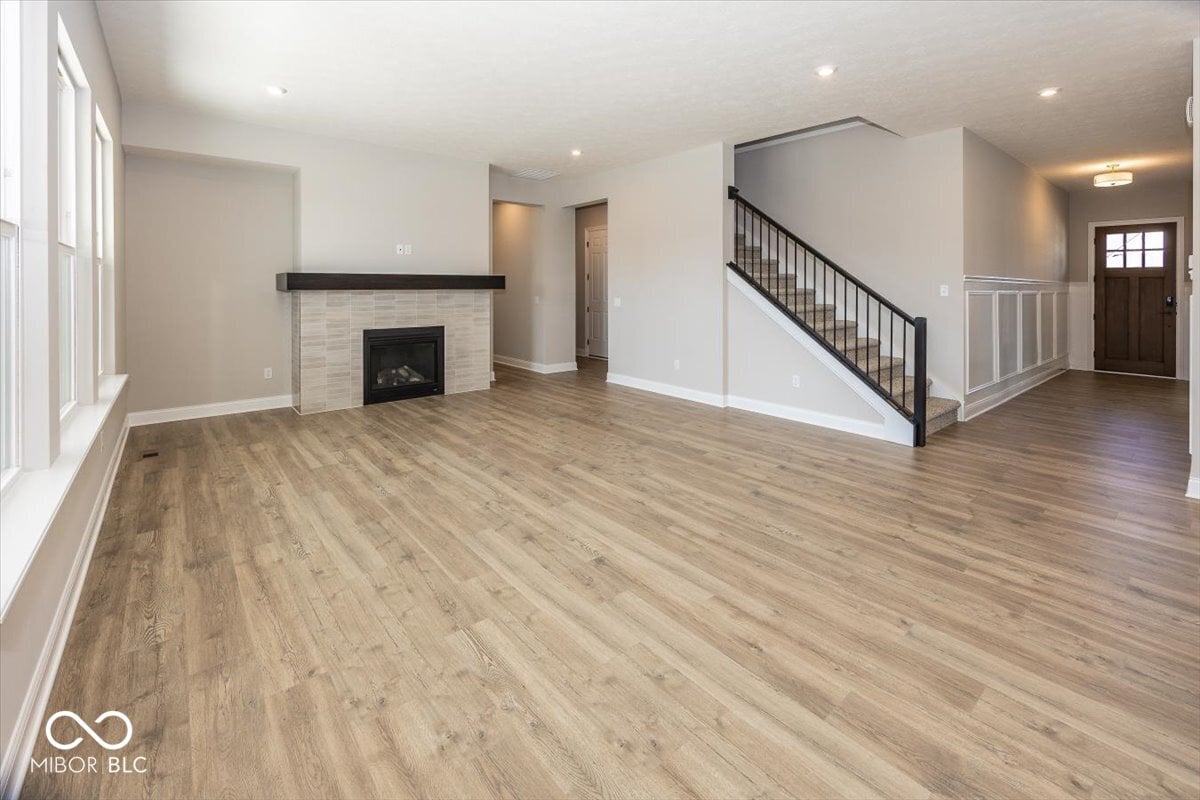 Bright open layout with fireplace and modern finishes.