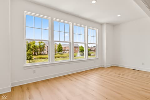 Bedroom at 15407 Mystic Rock Drive, Carmel, IN — Bright bedroom with expansive windows and hardwood floors.