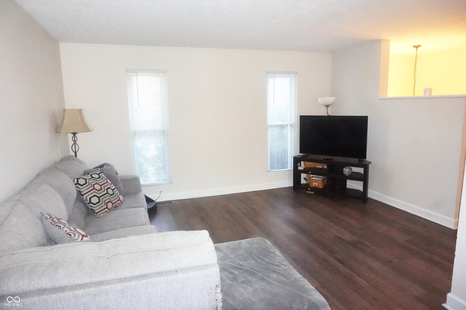 Bright living room with hardwood floors and natural light.