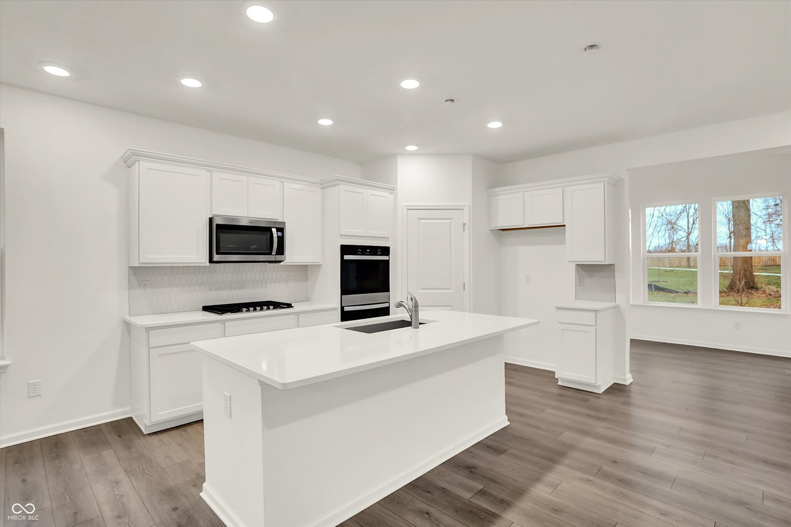 Bright modern kitchen with oversized island and quality finishes.