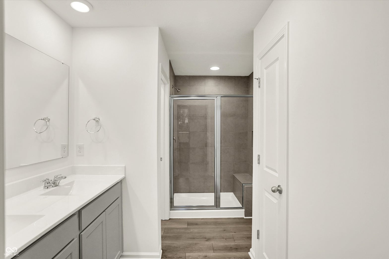 Spa-like primary bath with double vanity and walk-in shower.