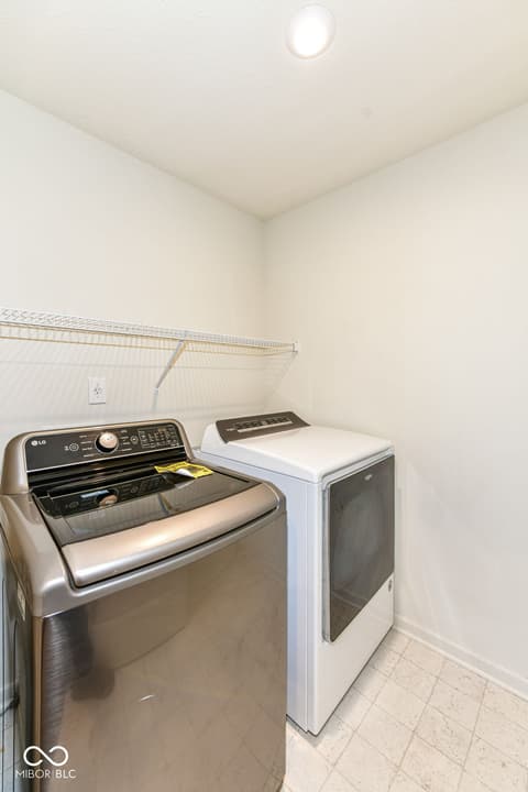 Laundry room at 13533 Dewpoint Lane, Fishers, IN — Modern laundry room with stainless steel appliances.
