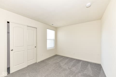 Bedroom at 13533 Dewpoint Lane, Fishers, IN — Bright bedroom with spacious closet and natural light.