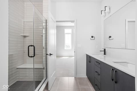 Primary bathroom at 1481 Whistle Way, Westfield, IN — Spa-like primary bath with walk-in shower and double vanity.
