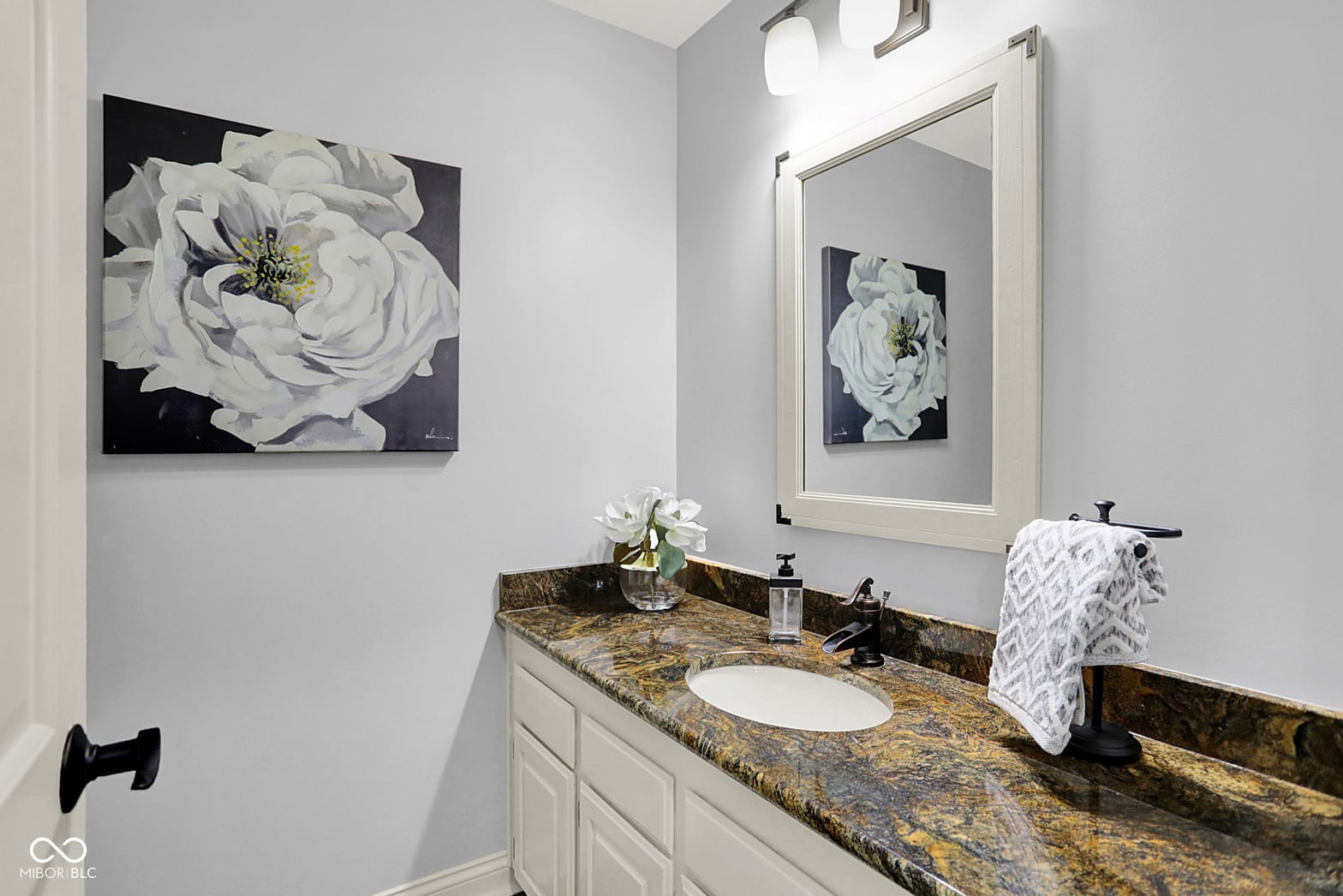 Elegant primary bath with granite counters and double vanity.