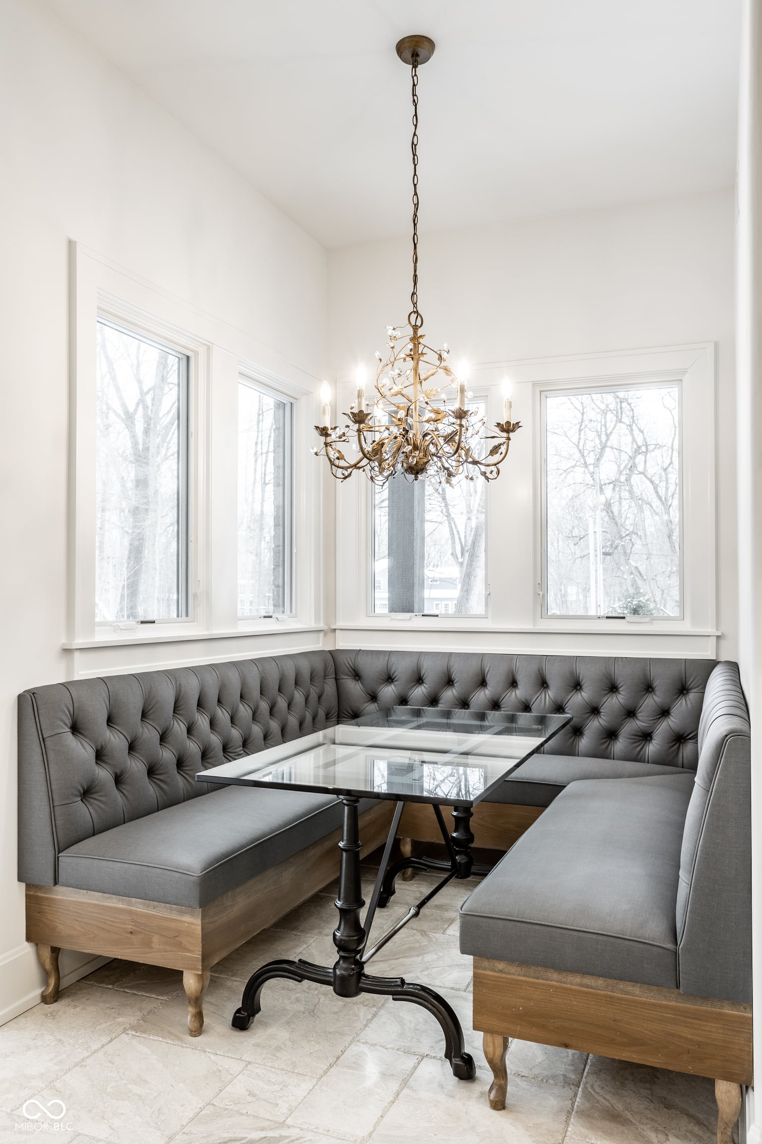 Elegant dining nook with custom tufted banquette seating.