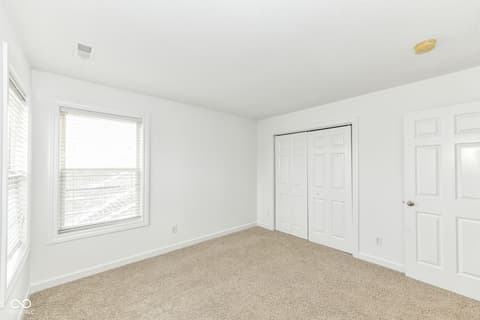 Bedroom at 11035 Cool Winds Way, Fishers, IN — Bright bedroom with double closet and ample natural light.