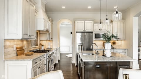 Kitchen at 13429 Boxelder Court, Carmel, IN — Chef's kitchen with granite, gas cooking, and large island.